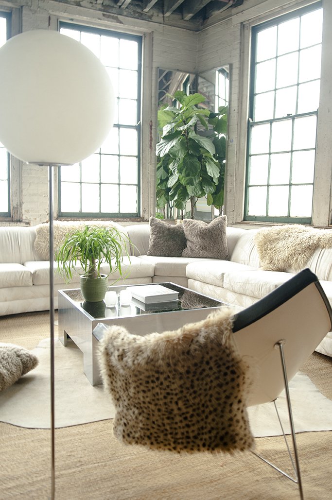 House of No Era's former Camp Washington warehouse studio in Cincinnati, Ohio, featuring a Postmodern Miami coastal-style setup with a Vladimir Kagan sculptural sectional sofa, George Nelson's Coconut Chair by Vitra, a Paul Mayen aluminum low-slung c