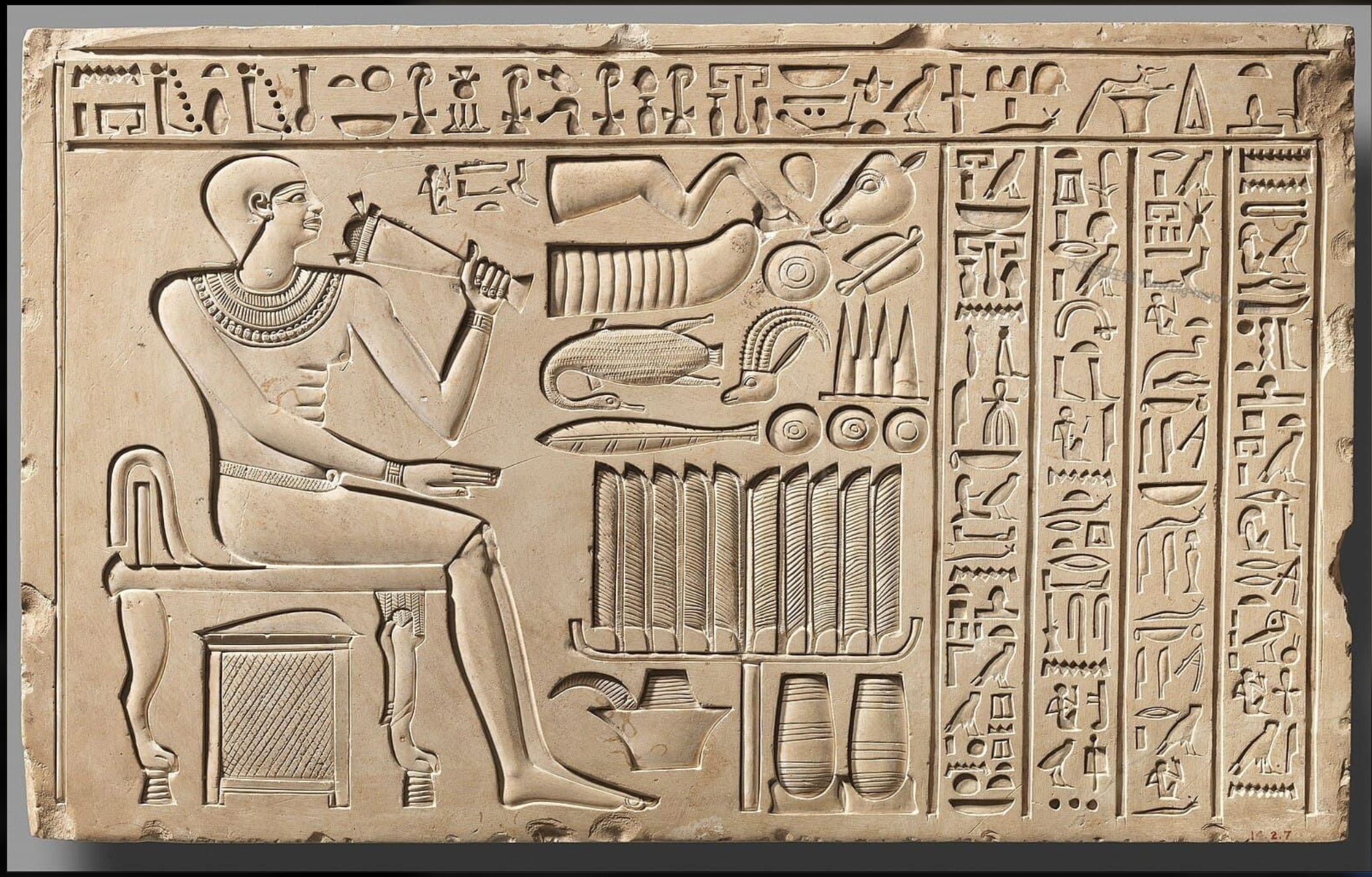 Ancient Egyptian stone stele depicting official Imrit seated in a backed chair, illustrating how seating represented rank and authority during the First Dynasty.