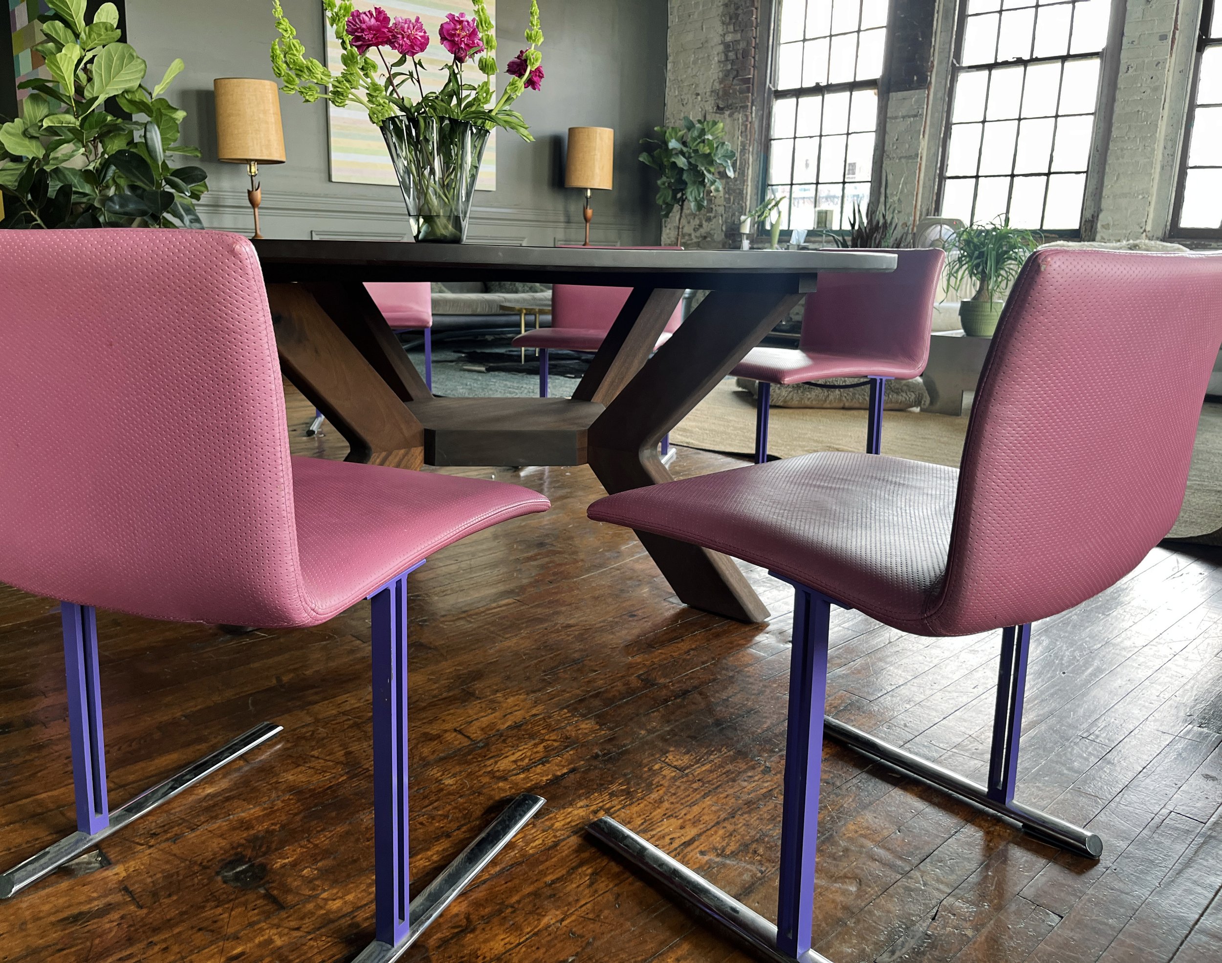 House of No Era's former historic loft studio in Camp Washington, Cincinnati, featuring a set of six 1970s Giovanni Offredi for Saporiti Italian dining chairs surrounding an oversized custom walnut sculptural dining table with a Brutalist base, paire