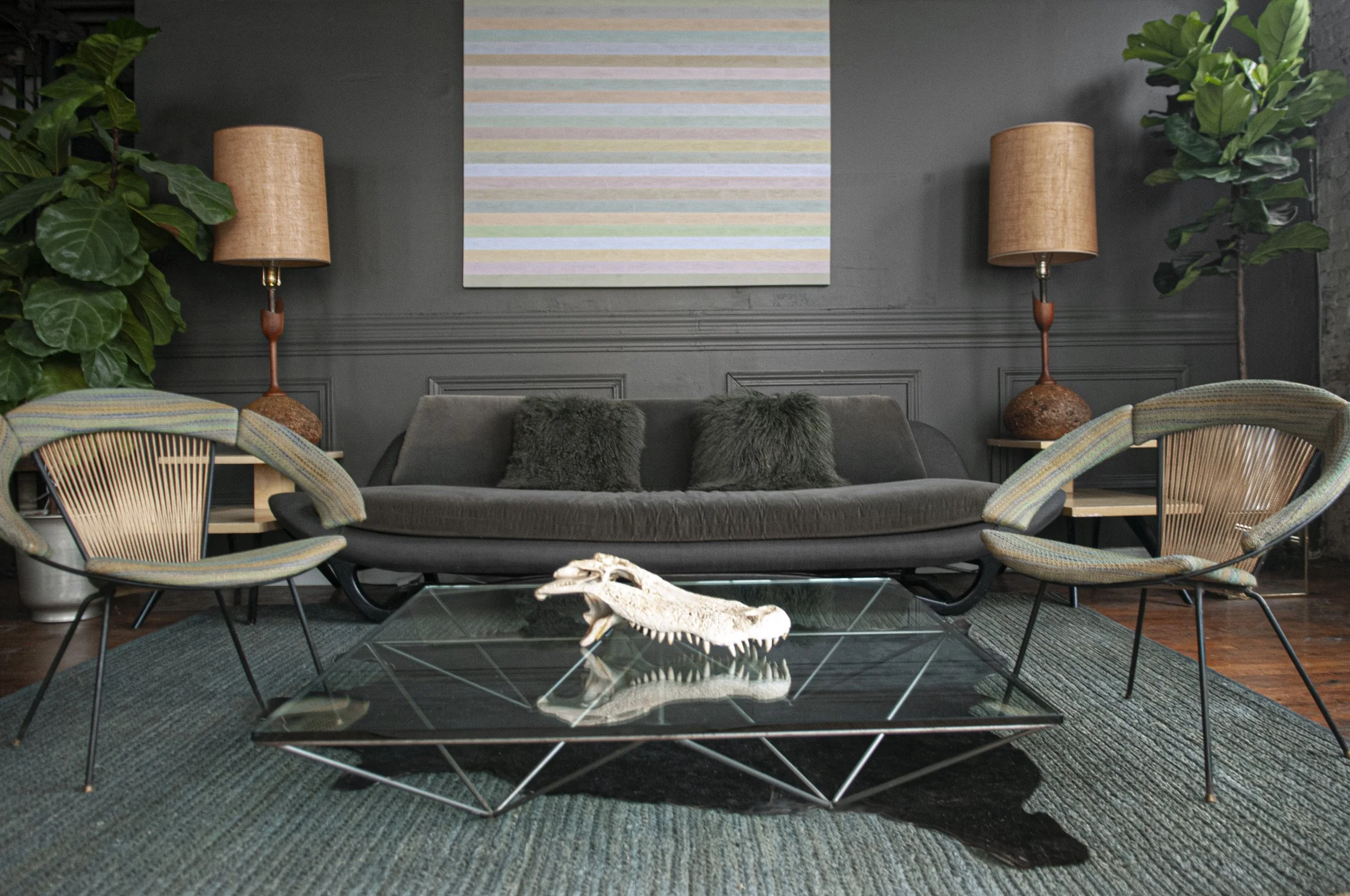House of No Era's former Camp Washington warehouse studio in Cincinnati, Ohio, featuring No Era's Brutalist Pop Tropics set design with an Alanda coffee table by B&B Italia, a pair of Laurel Lamp Co. cork table lamps, a 1950s Brown Saltman Gondola so