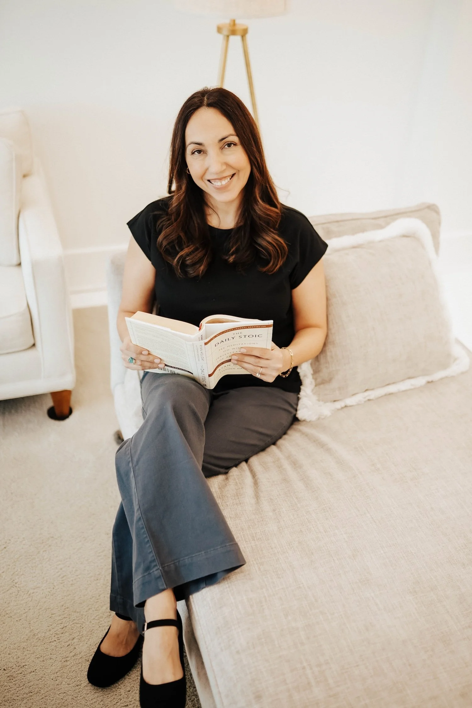 Tonya seated comfortably with a notebook, ready to help clients gain clarity and move forward with purpose.