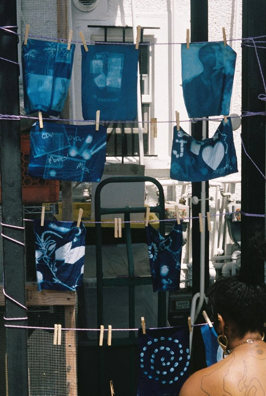Washed cyanotype photograms of various workshop participants hang out to dry in the Inglewood sun. Photo by Marvin James for Its-in-Scope.