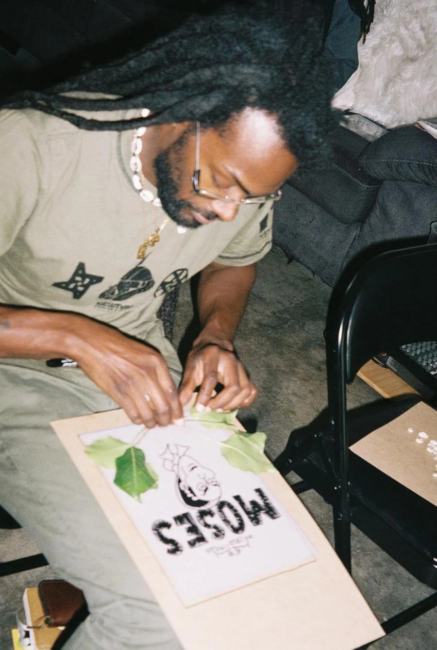 Artist Phill Burrows illustrates and composes his cyanotype. Photo by Marvin James for Its-in-Scope.