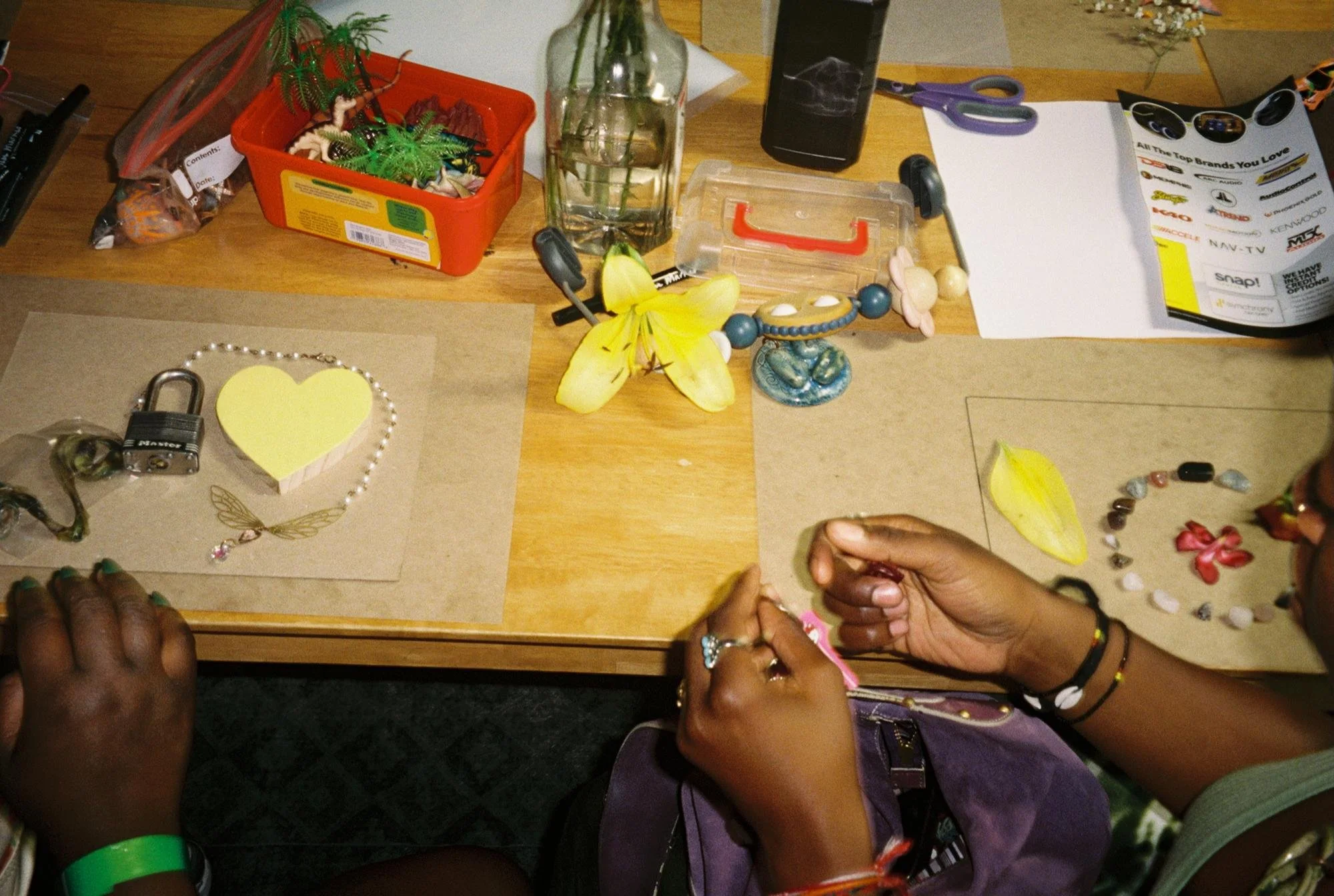 Workshop participants use objects, plants, and transparencies to build their cyanotype compositions. Photo by Marvin James for Its-in-Scope.