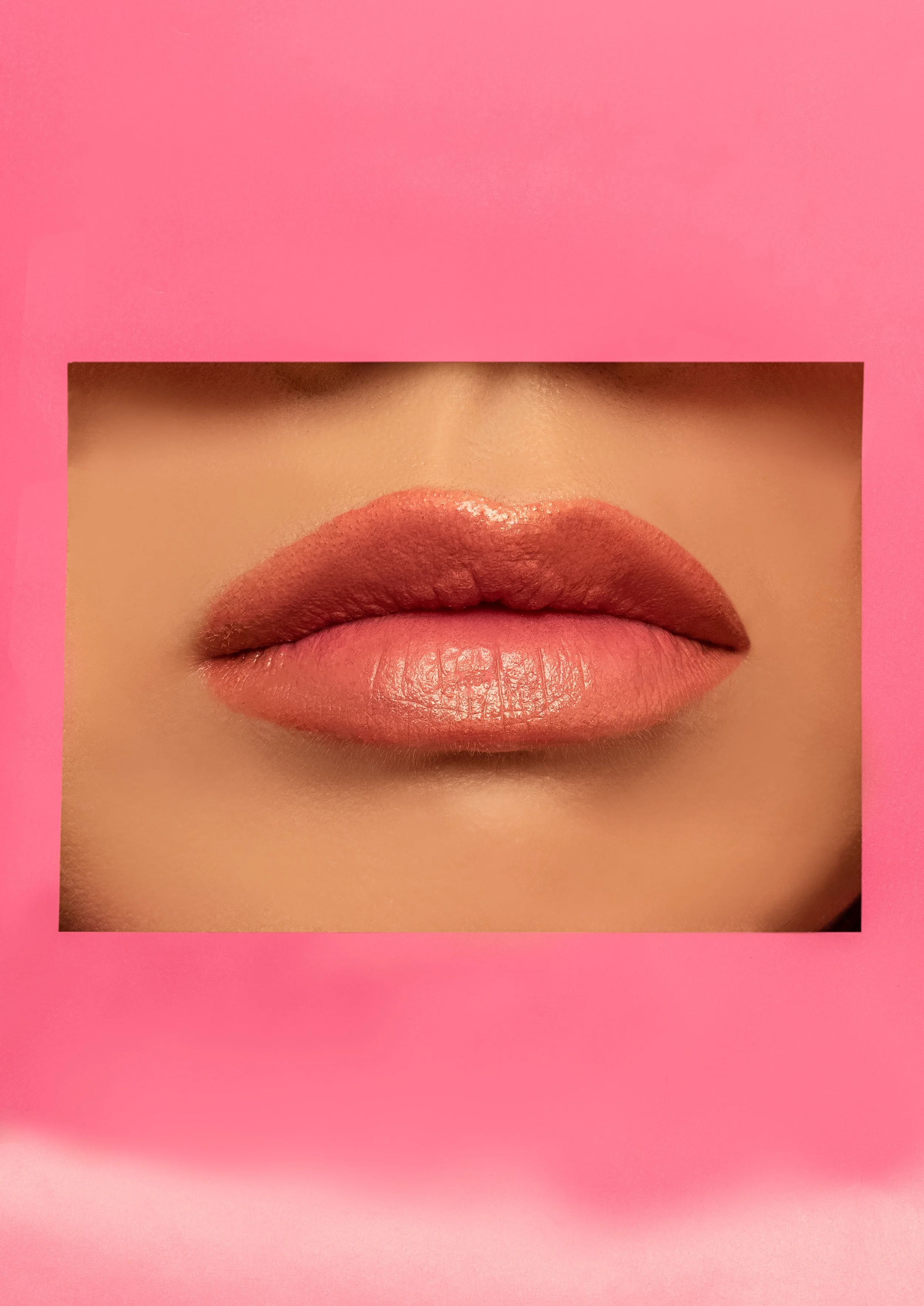 Close-up of lips with pinkish-brown lipstick, framed by a pink square with a cutout window.