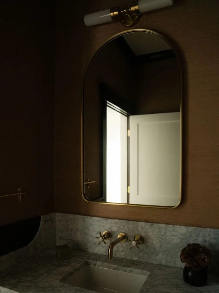 Welcome to Cresthill Ave, our newly completed interior remodel here in Atlanta! 

Next up, we'd like to introduce you to the powder bathroom! Dark-painted wood wainscoting and a custom floating marble vanity bring a sense of quiet luxury, while tonal