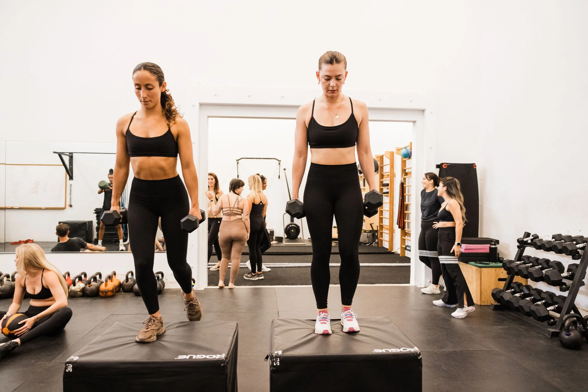 Members using dumbbells during an unheated strength training class at Asteya in Encinitas.