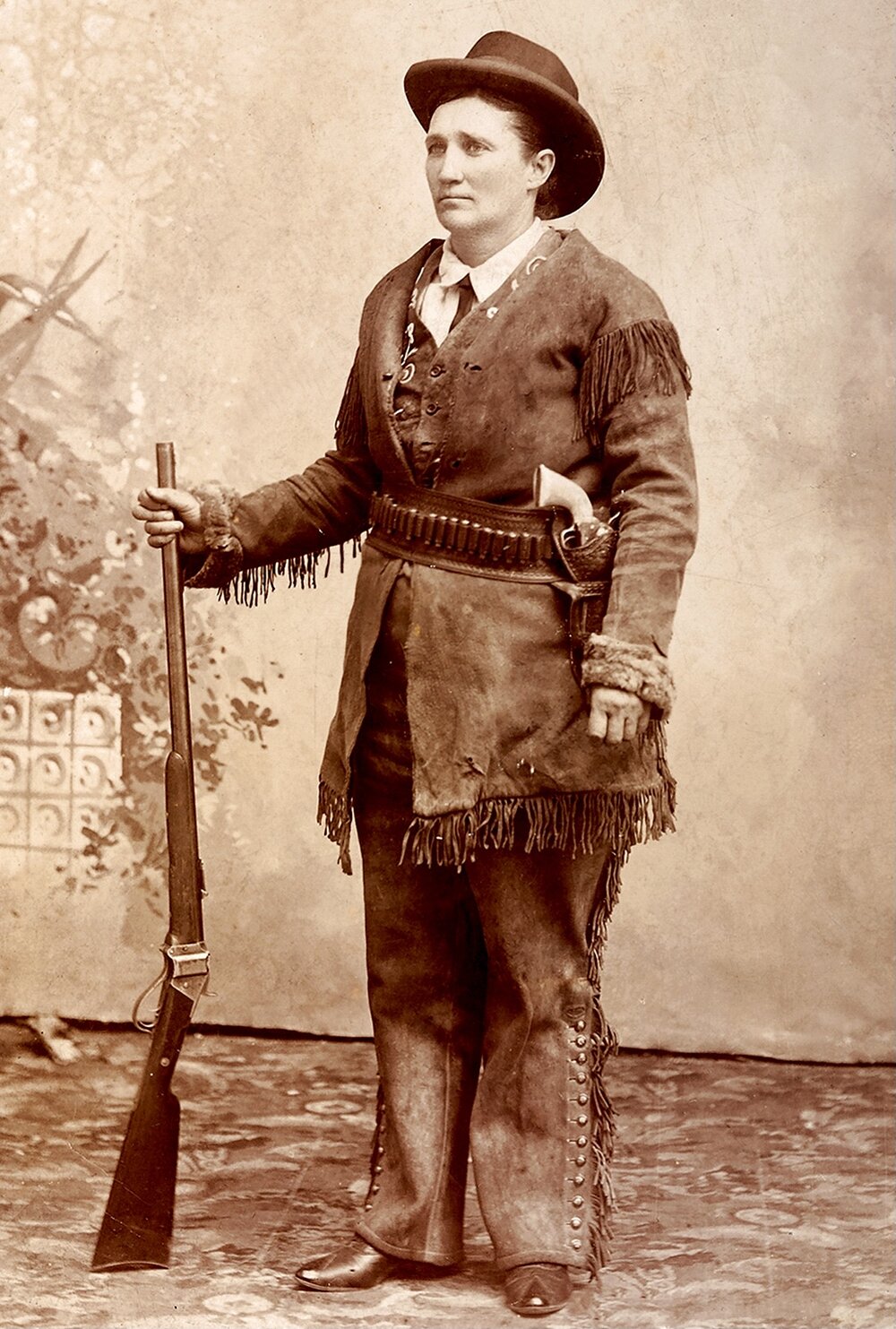 Calamity Jane in buckskins with ivory-gripped Colt revolver and Sharps rifle