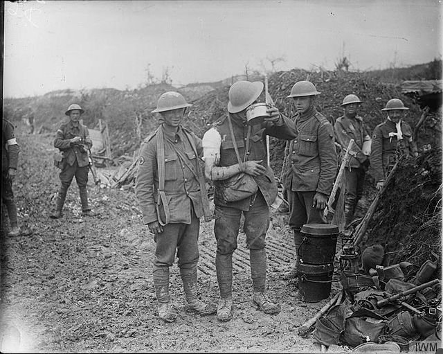 Wounded soldier being given food and water