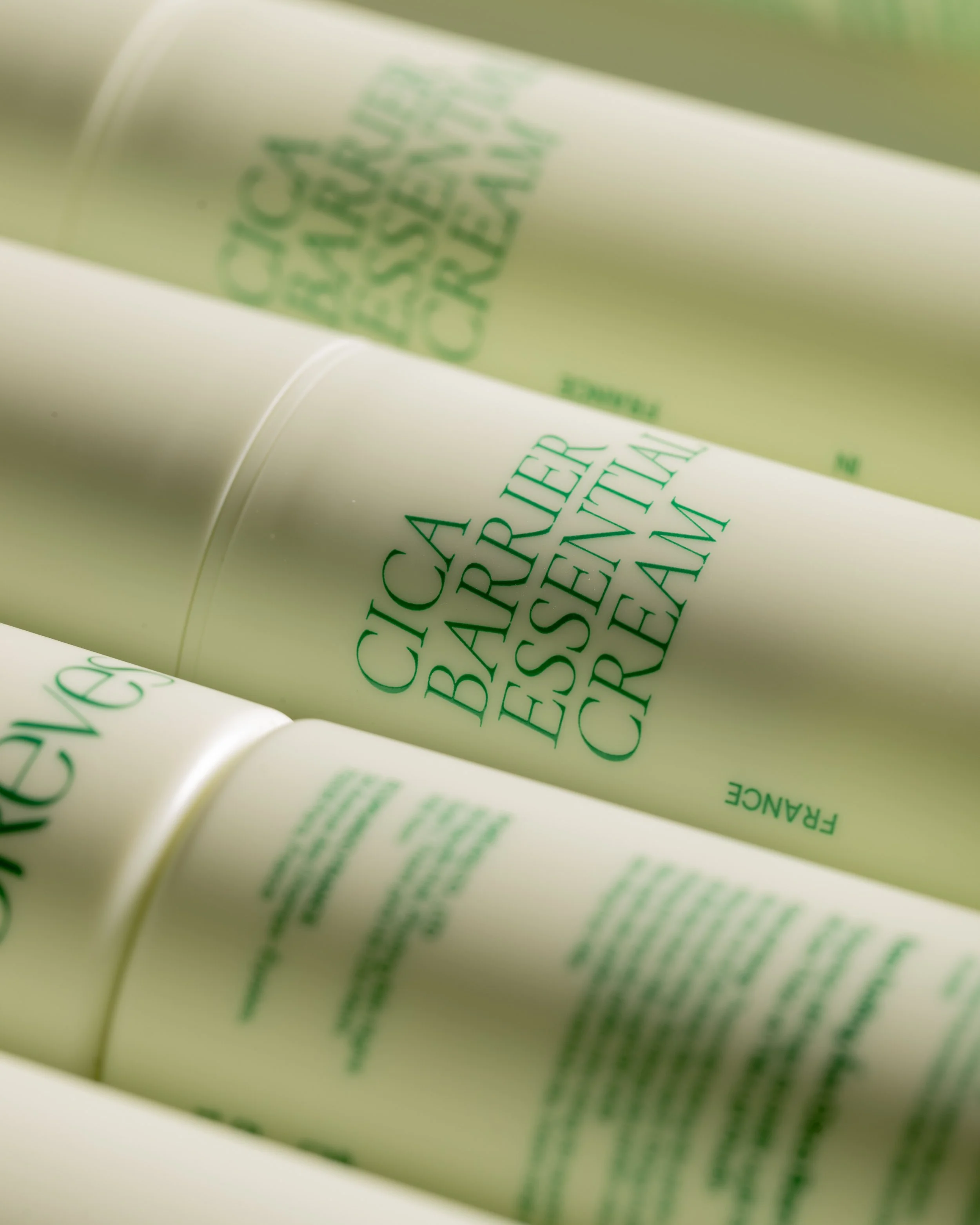Close-up of a bottle with green text and logo, partially visible and out of focus.