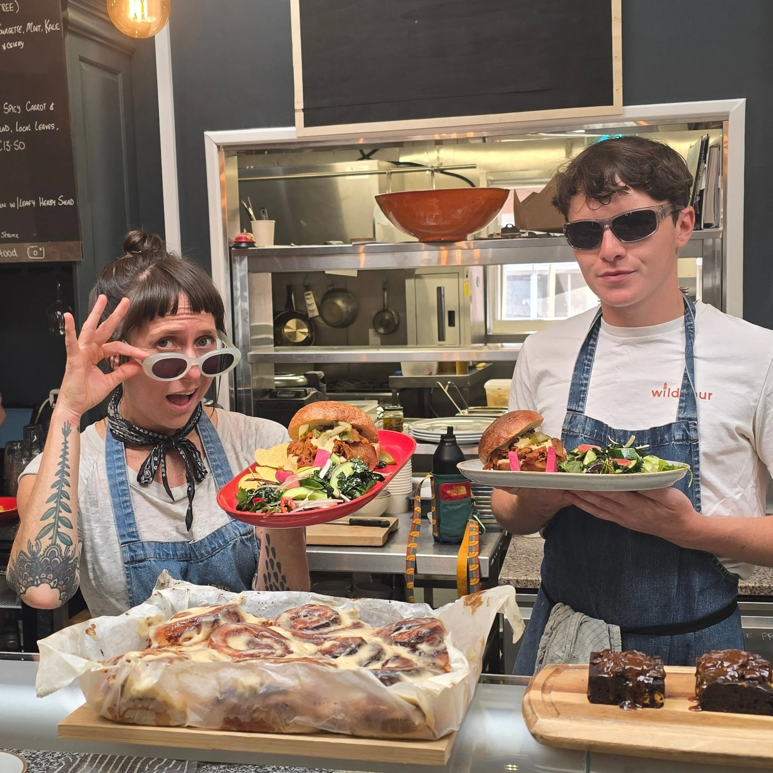 I don't know who needs to hear this, but we have a ham n chz brioche bap on today with local leafy greens, and an ice cold glass of mint mat&eacute; to celebrate the win last night.  You know it's all vegan and home made.  The tall cakes are vanilla 