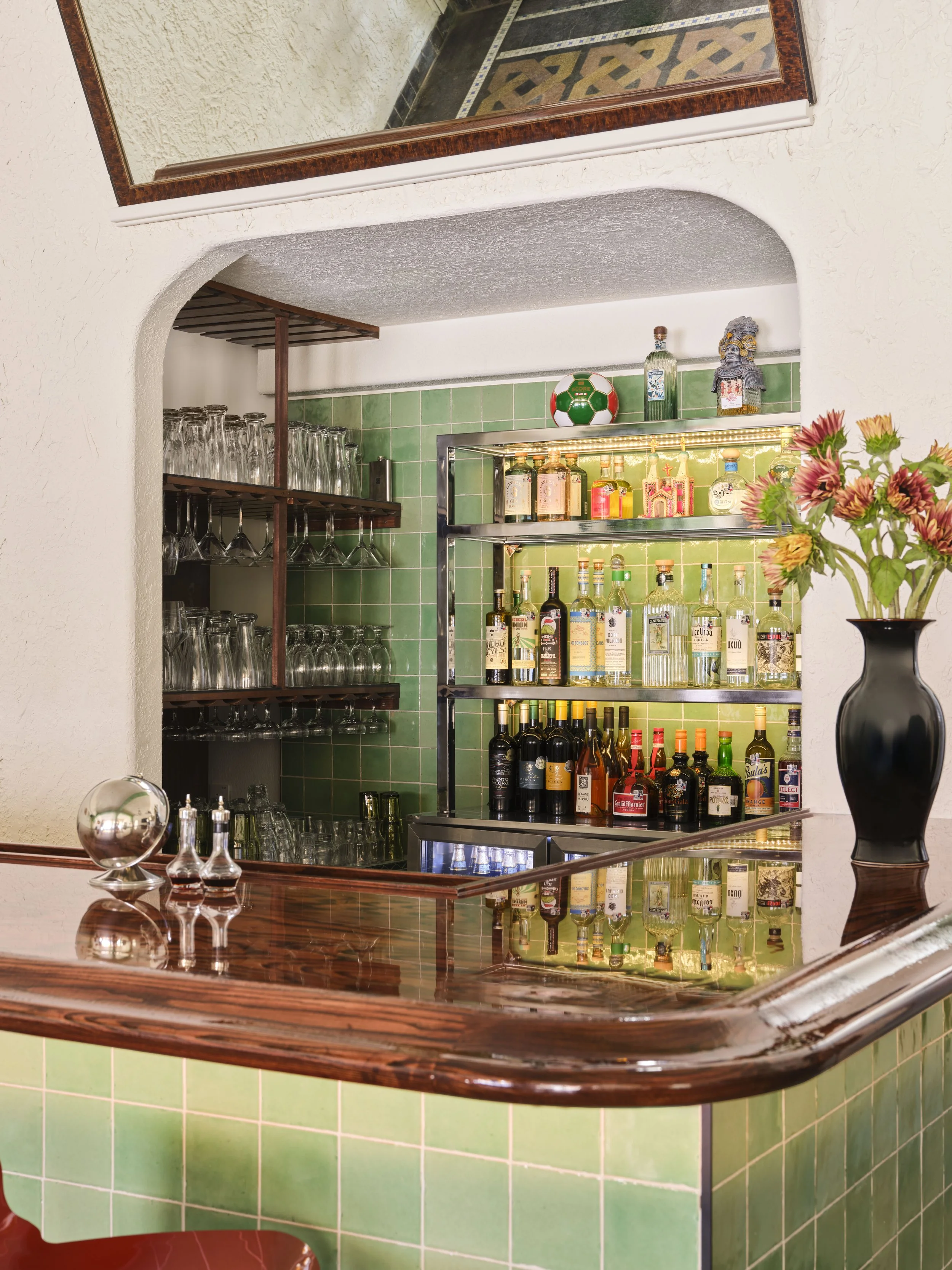 Bar close-up with custom steel shelving and wood bartop