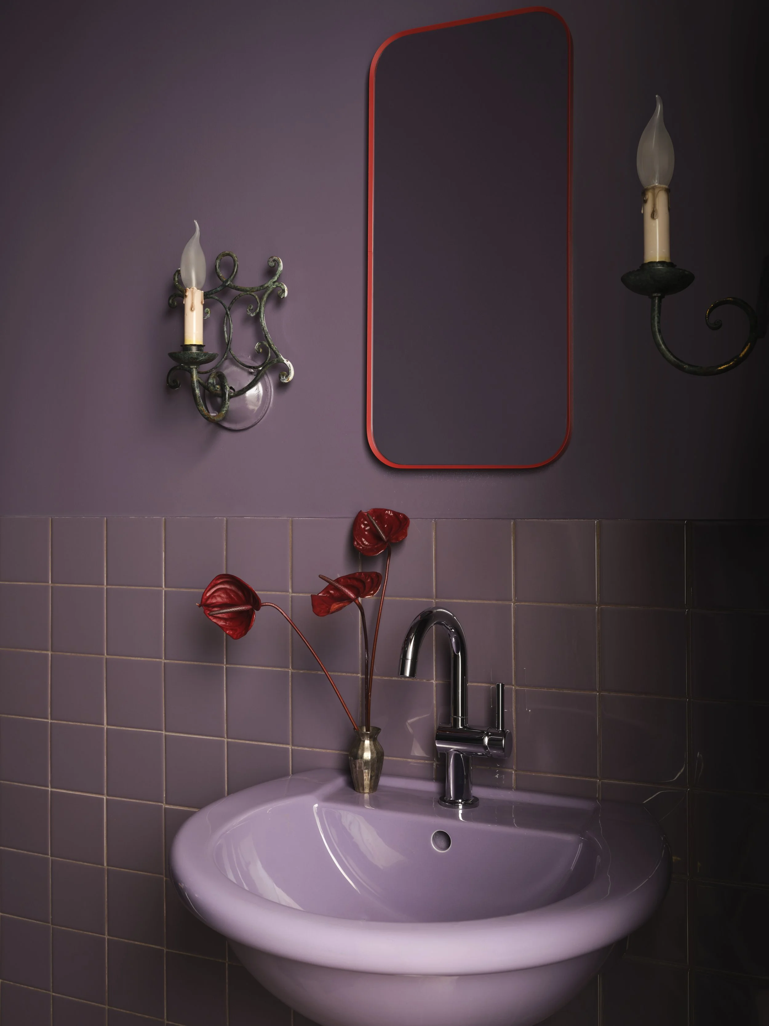 Color-washed purple bathroom with unexpected red pops