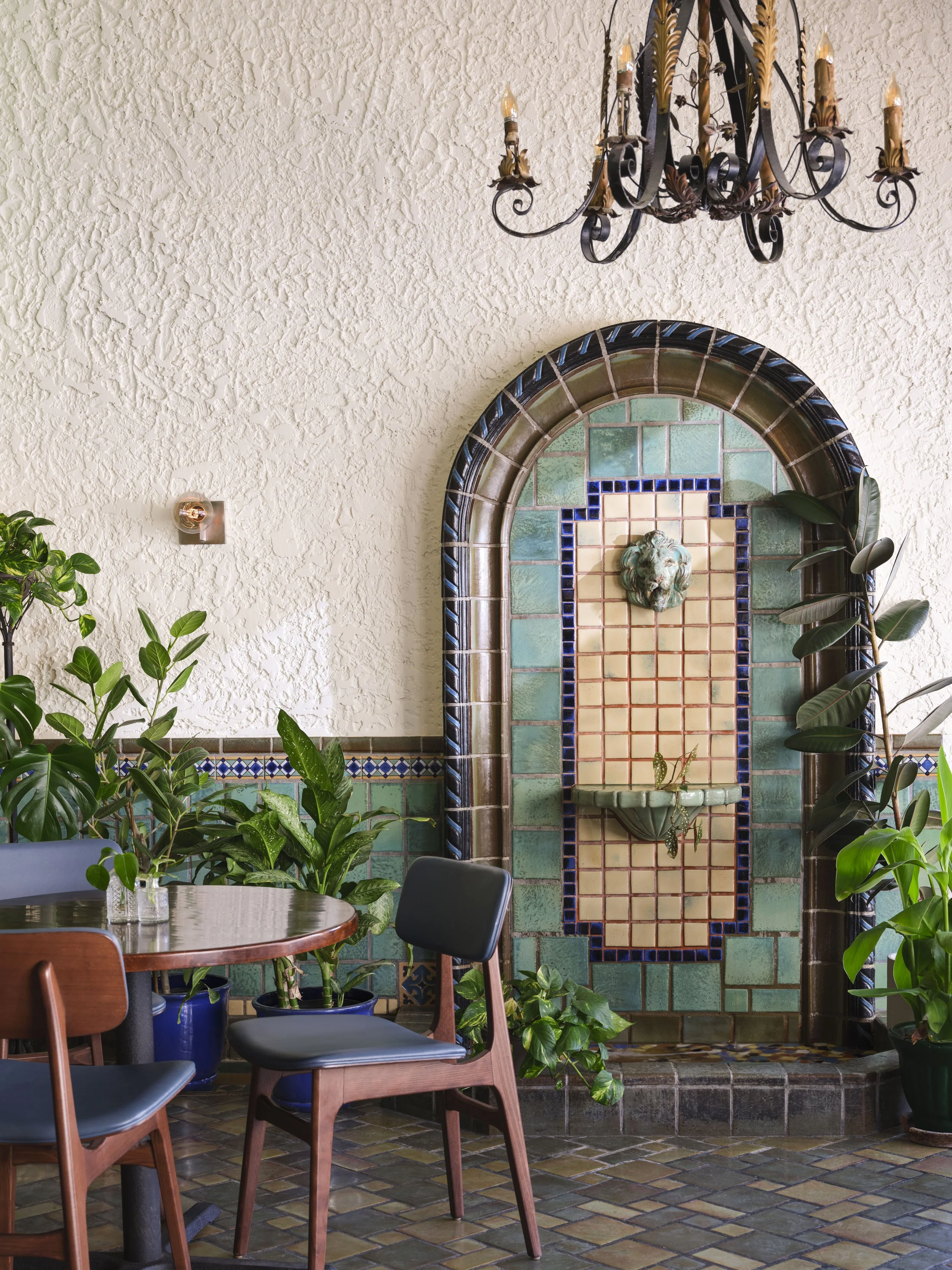 A tiled fountain with table and chairs