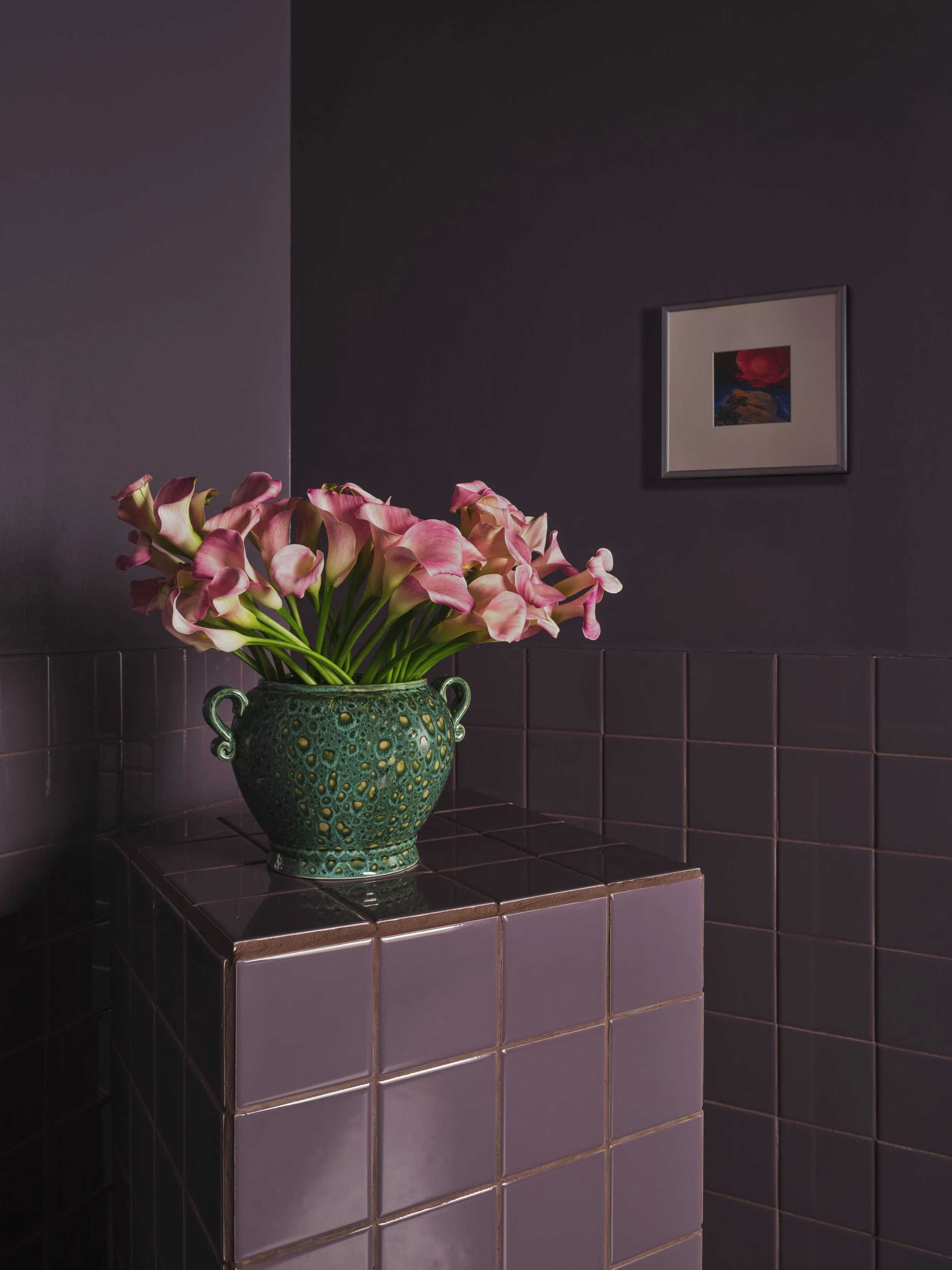 Purple color-washed bathroom with a tile pedestal