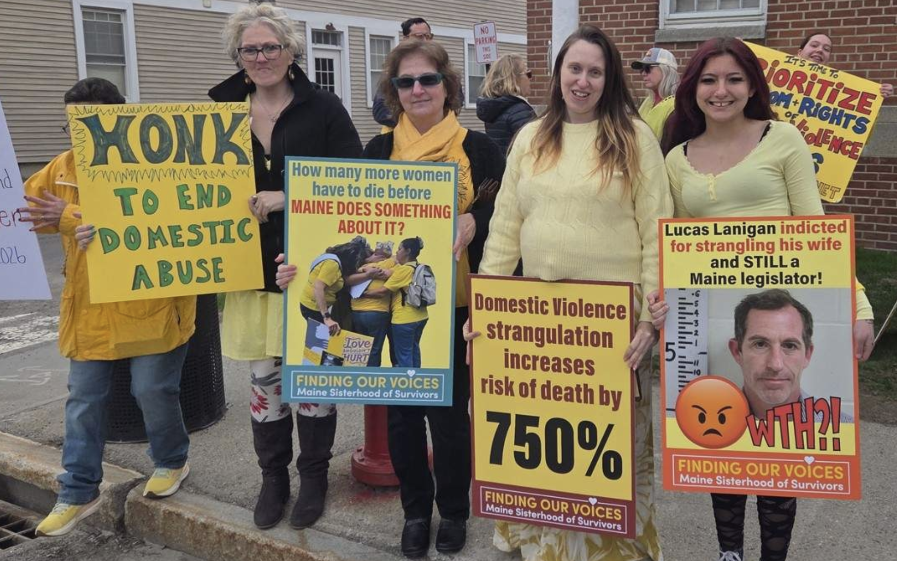 Demonstrators dressed in bright yellow rally against local cases of femicide and domestic violence