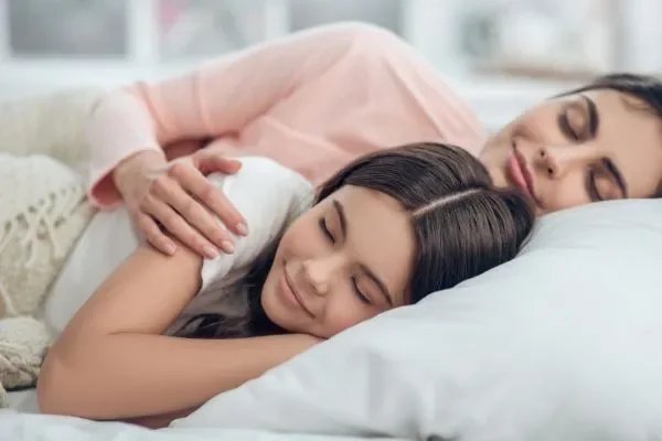 Parent and teen peacefully sleeping together