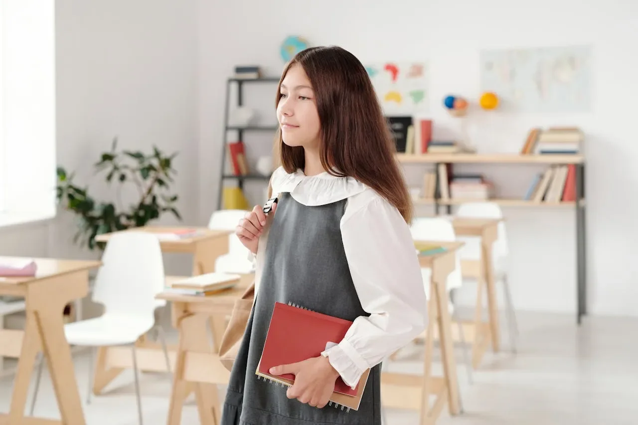 middle school student holding her notebook