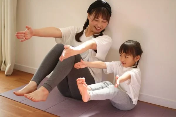 Parent helping child with balance skills