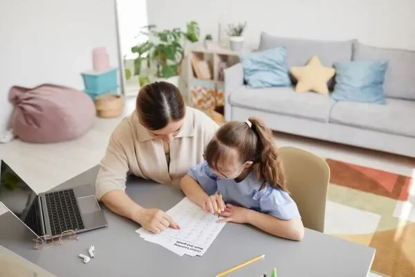 Parent assisting child with ADHD studying