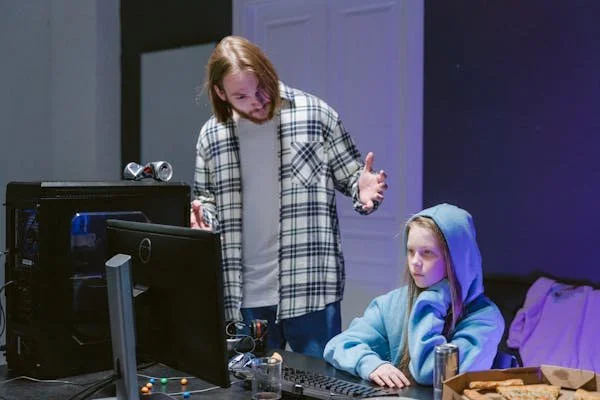 Father scolding child for using computer.jpg