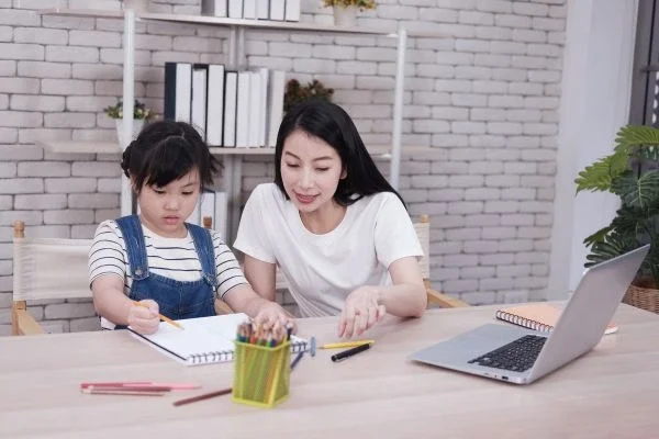 Parent guiding child during learning activity