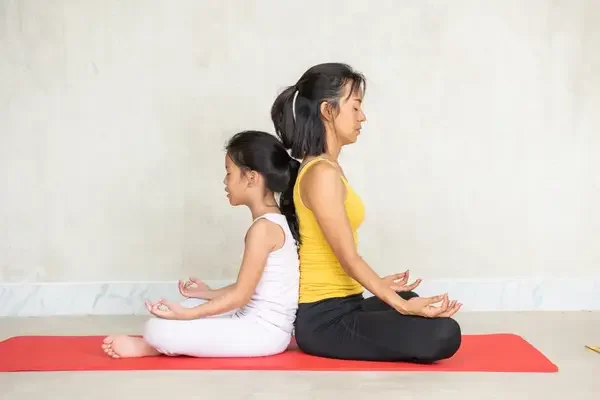 Mother and daughter doing yoga