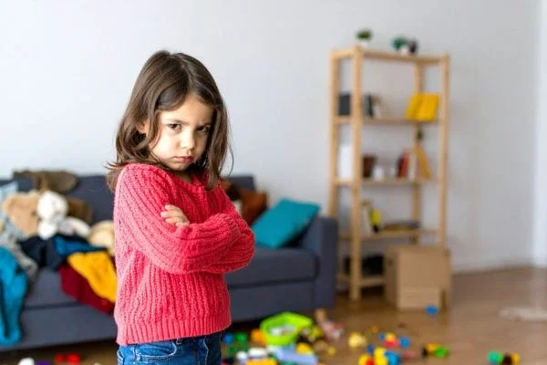 Child expressing irritation through facial expression