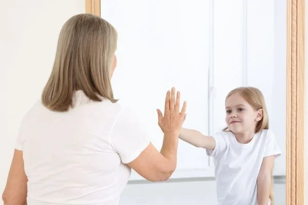 Parent giving high five to child