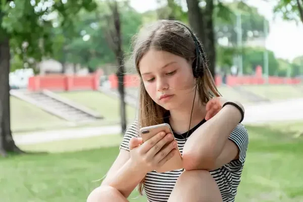 A teen using her phone