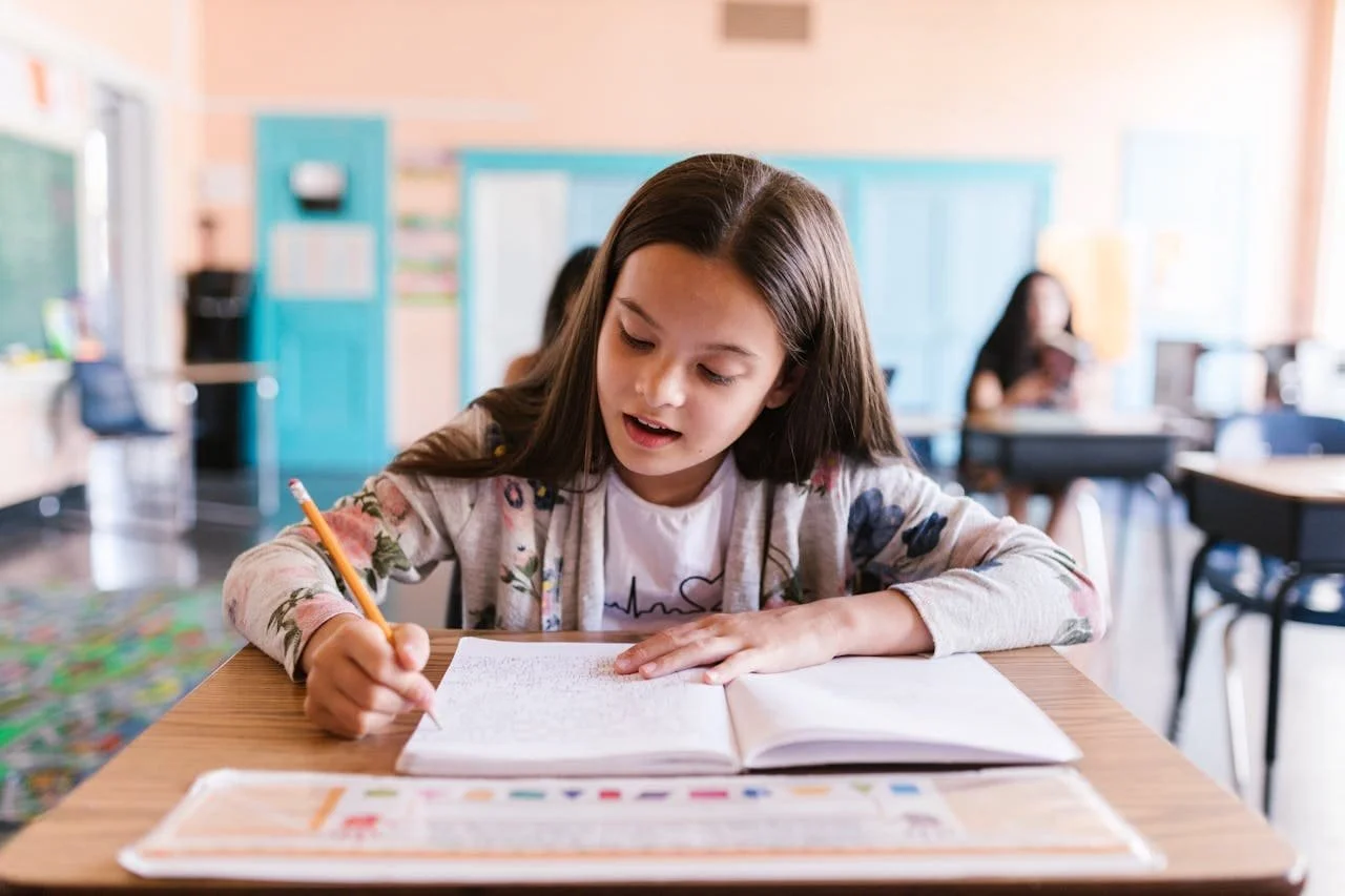 executive function student writing on a notebook