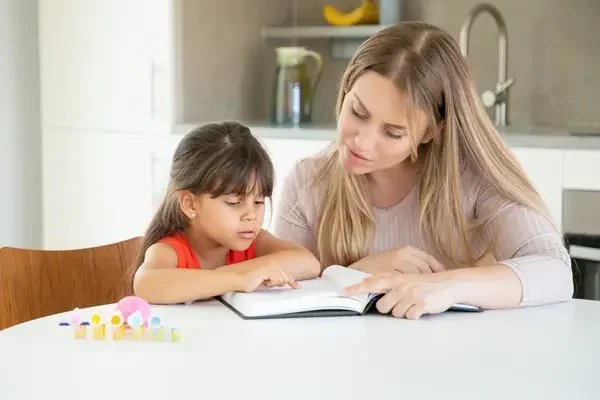 Mother helping her daughter's homework