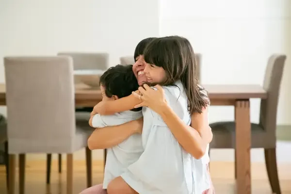Mother hugging her children