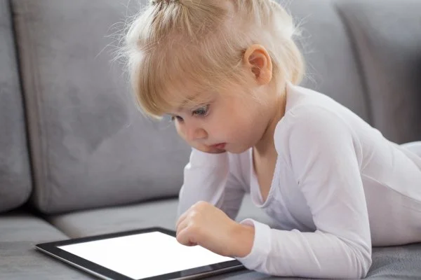 Child interacting with a tablet.