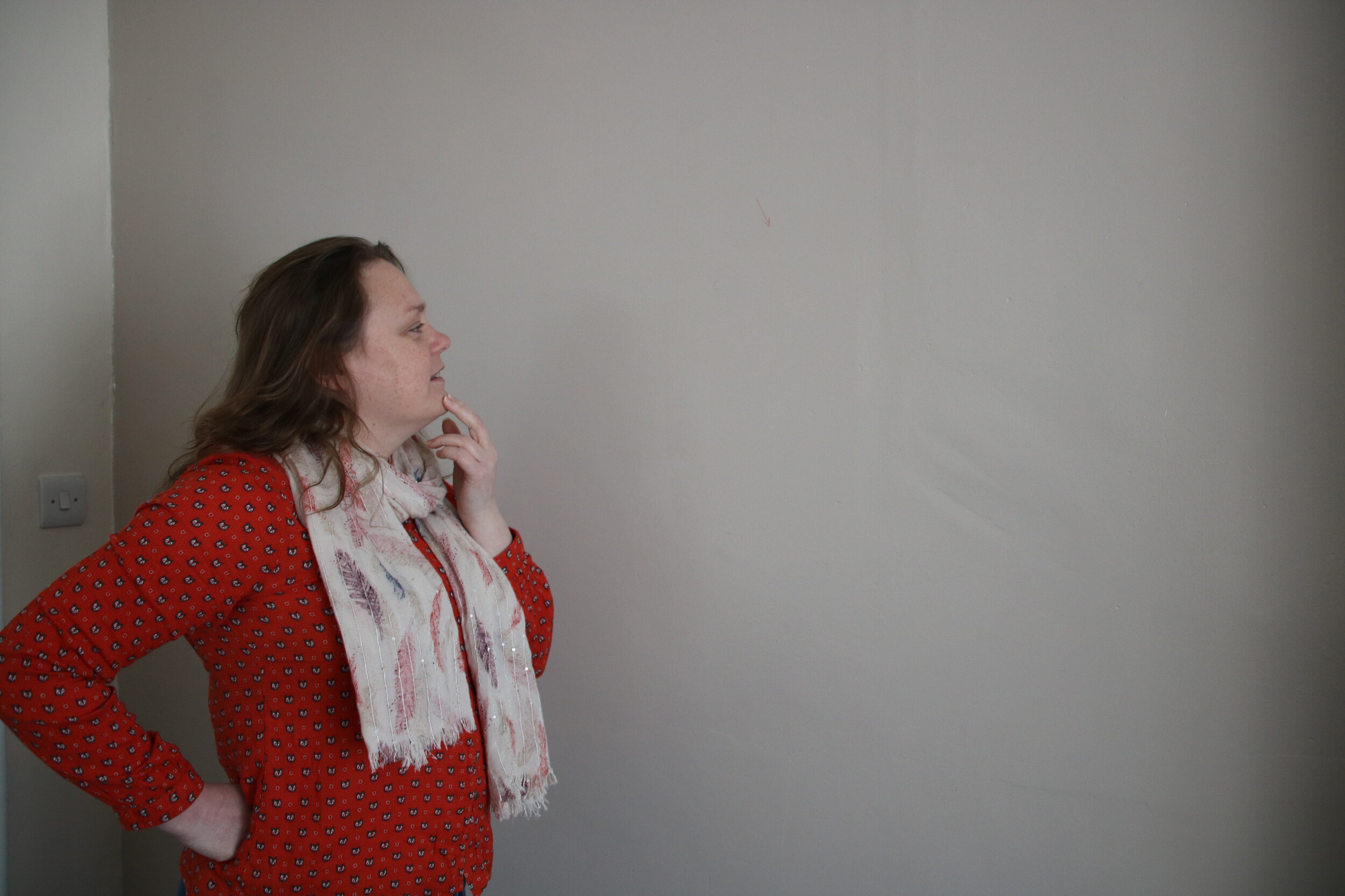 Karen admiring the blood spatter wall; you can hardly tell it's covered in blood!