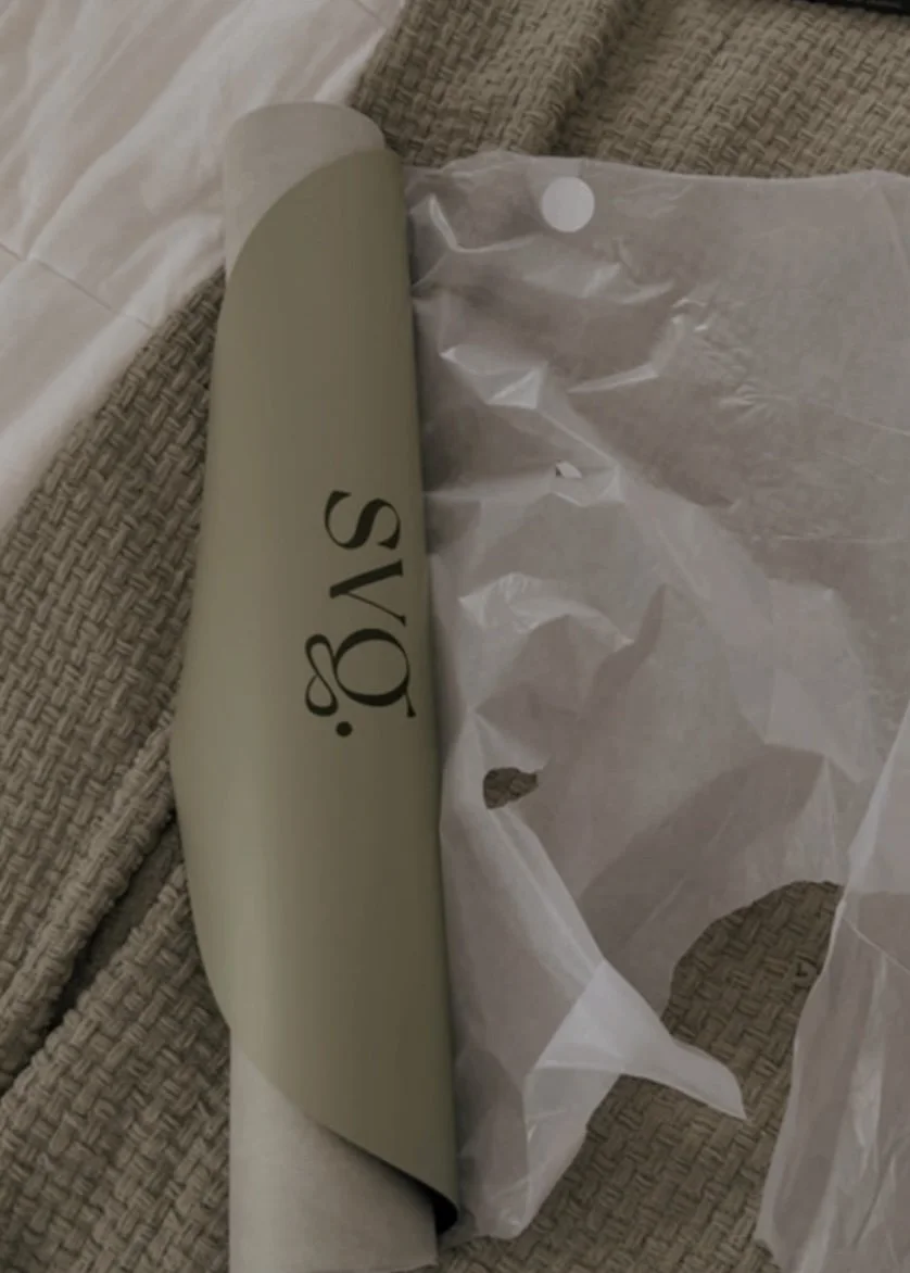 unboxing of the oliva verde capsula mat on a bed.