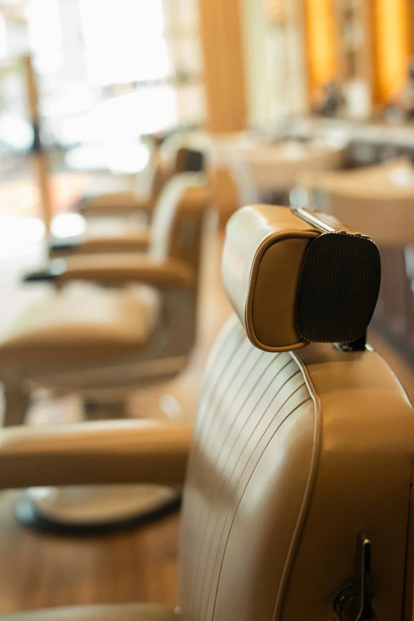 Master barber delivering a precision haircut and individual consultation at The Rosemont Barbers RiNo location.