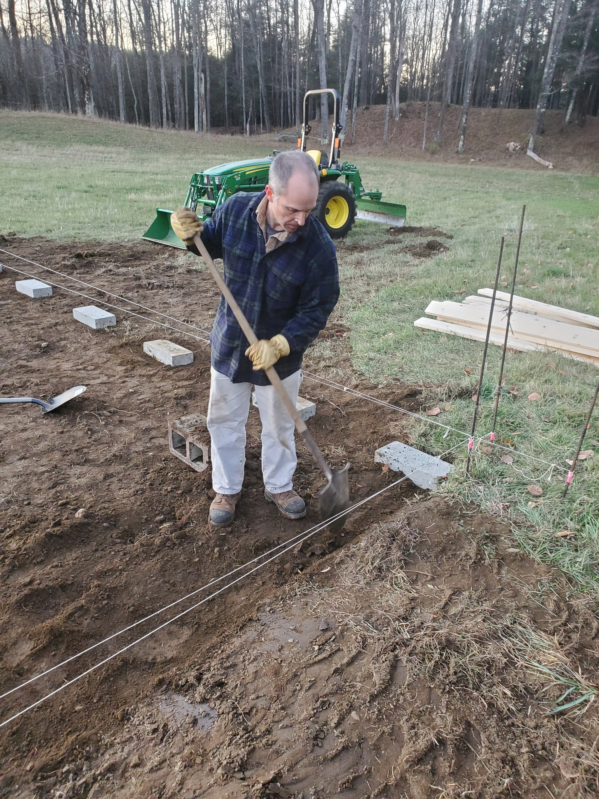 Leveling the ground and setting the foundation cinder blocks