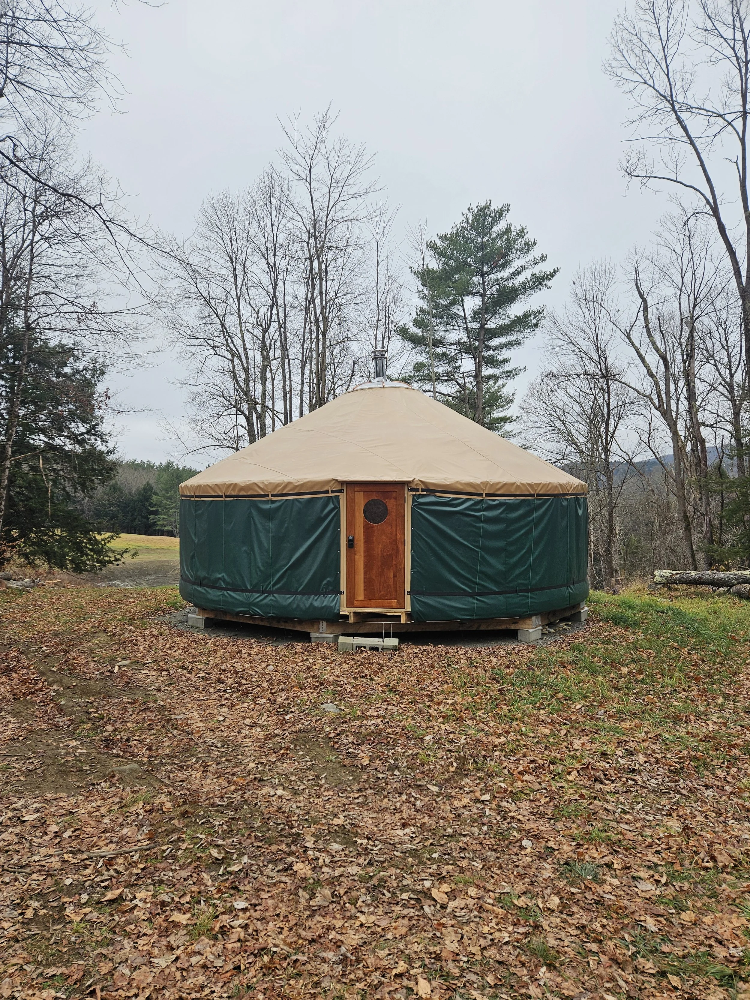 Yurt raising finished, with the door installed. Ready for the winter.