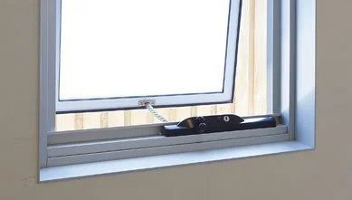 Open window with a metal safety latch and chain limiter