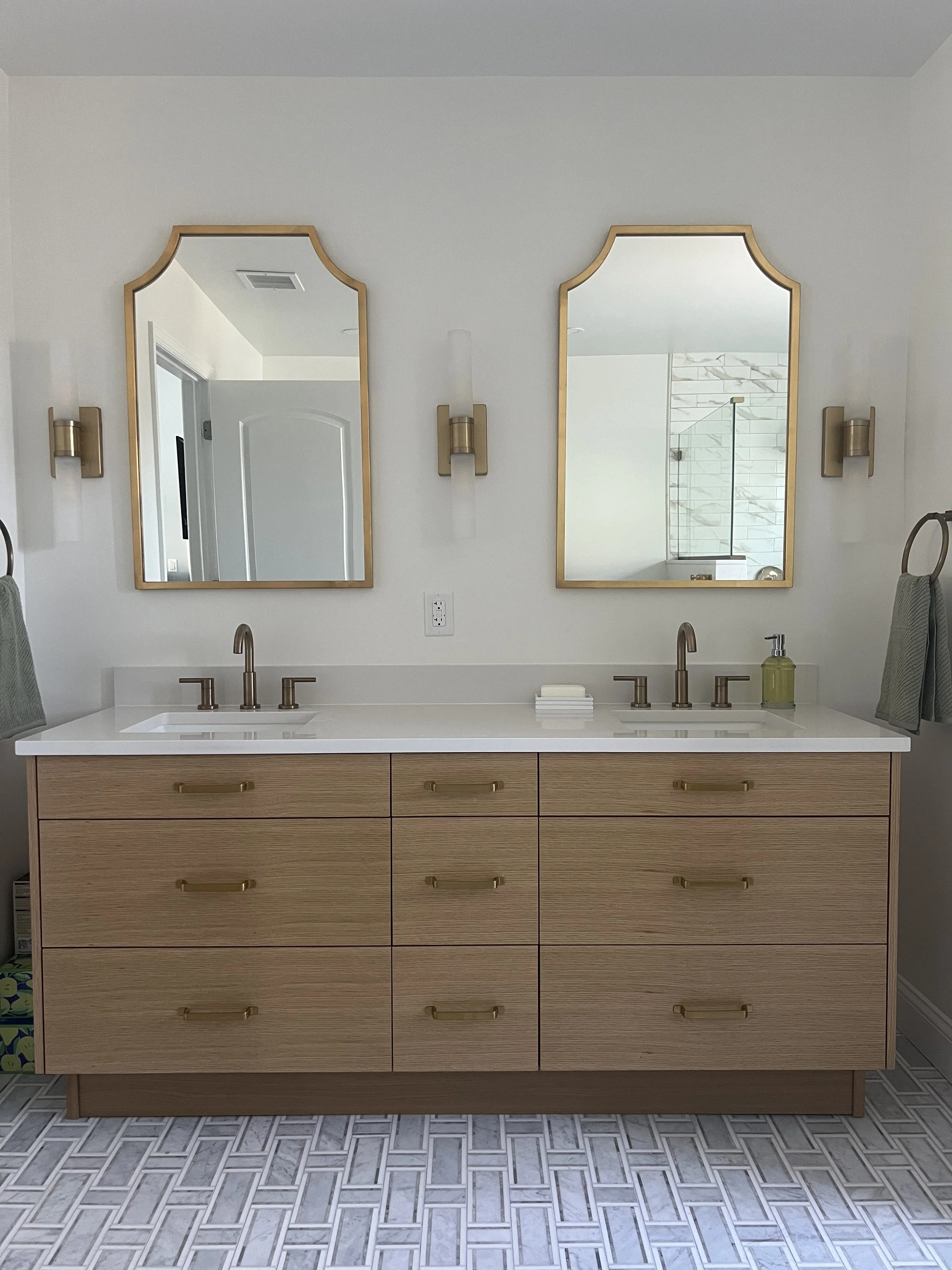 primary-bathroom-light-oak-vanity-gold-mirrors-marble-tile.JPG