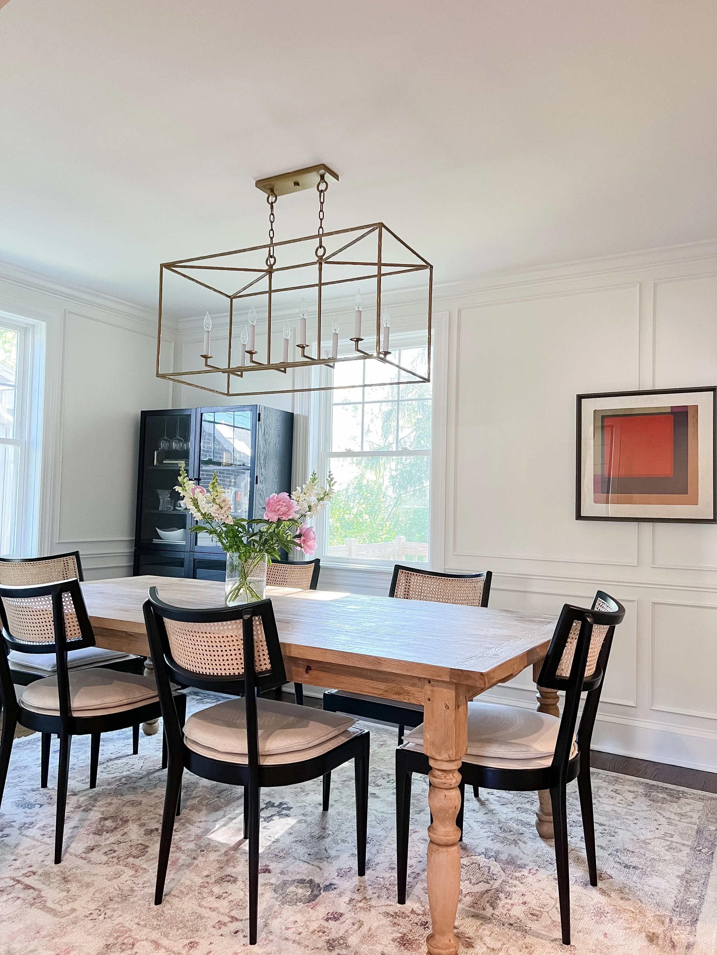 transitional-dining-room-wood-table-black-chairs-linear-chandelier.JPG