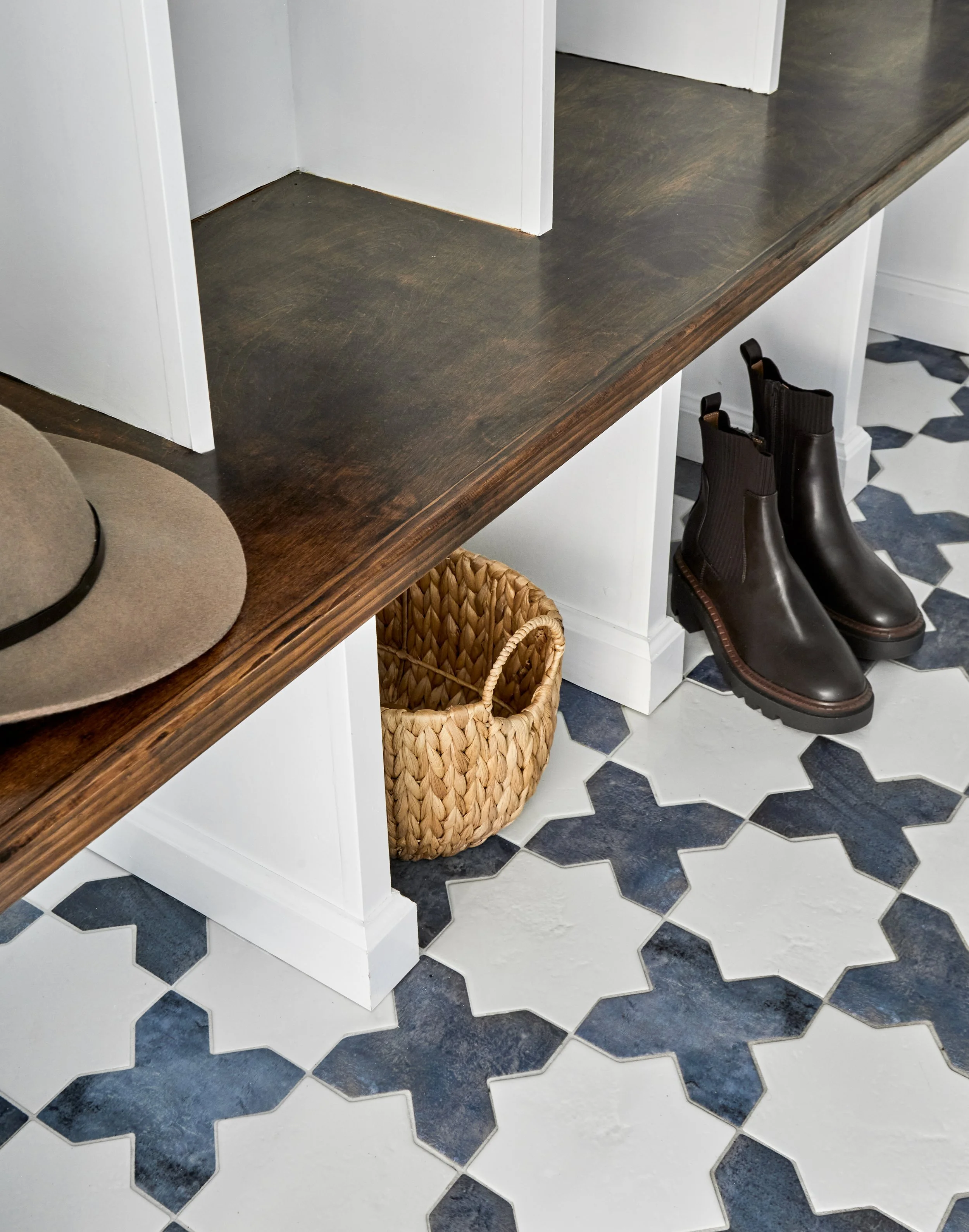 mudroom-dark-wood-bench-geometric-tile-floor-baskets.jpg