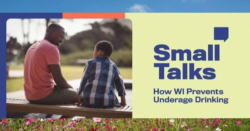 A father speaking to his son about underage drinking while sitting on a bench.