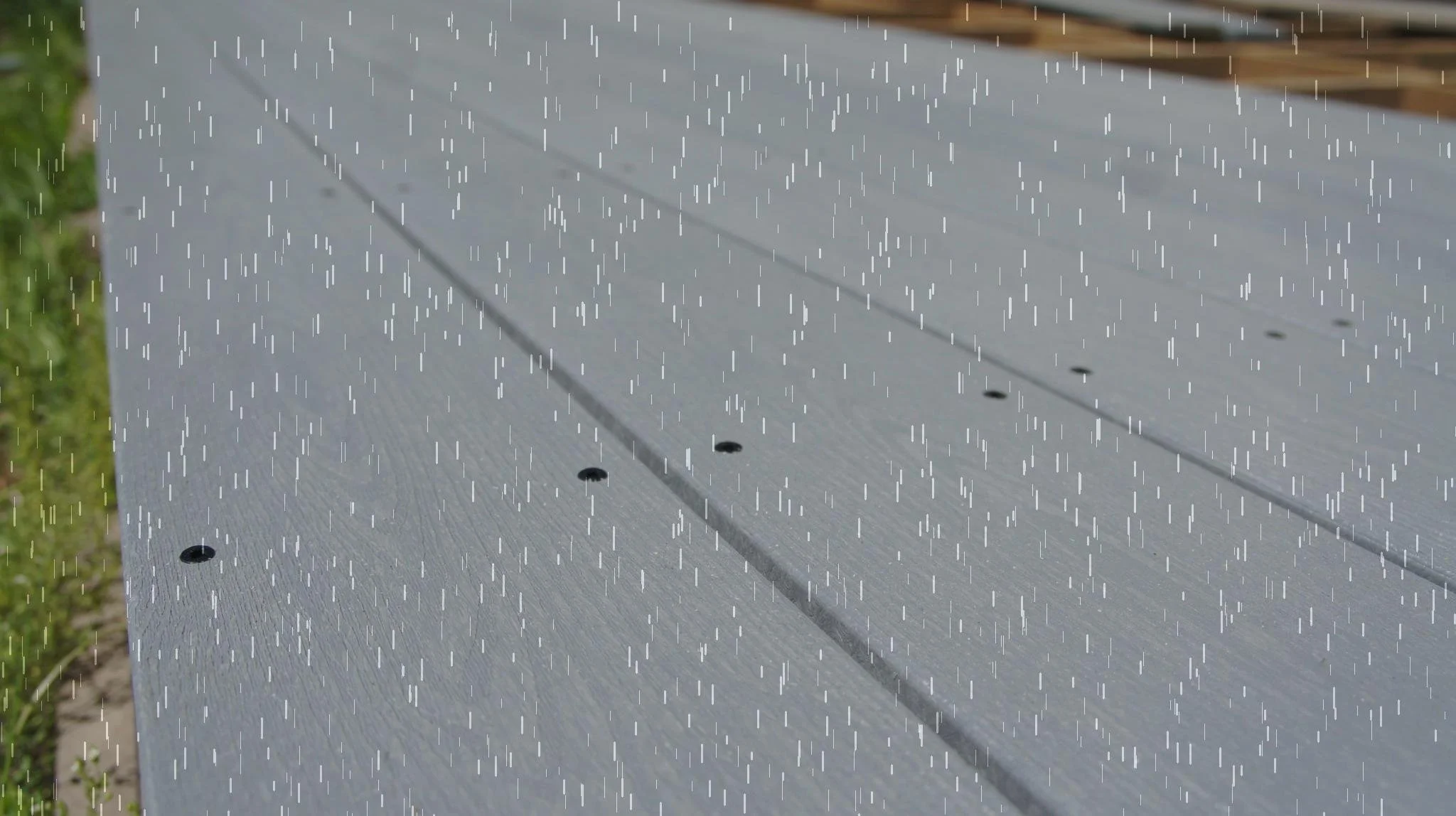 Plastic Lumber decking being rained on