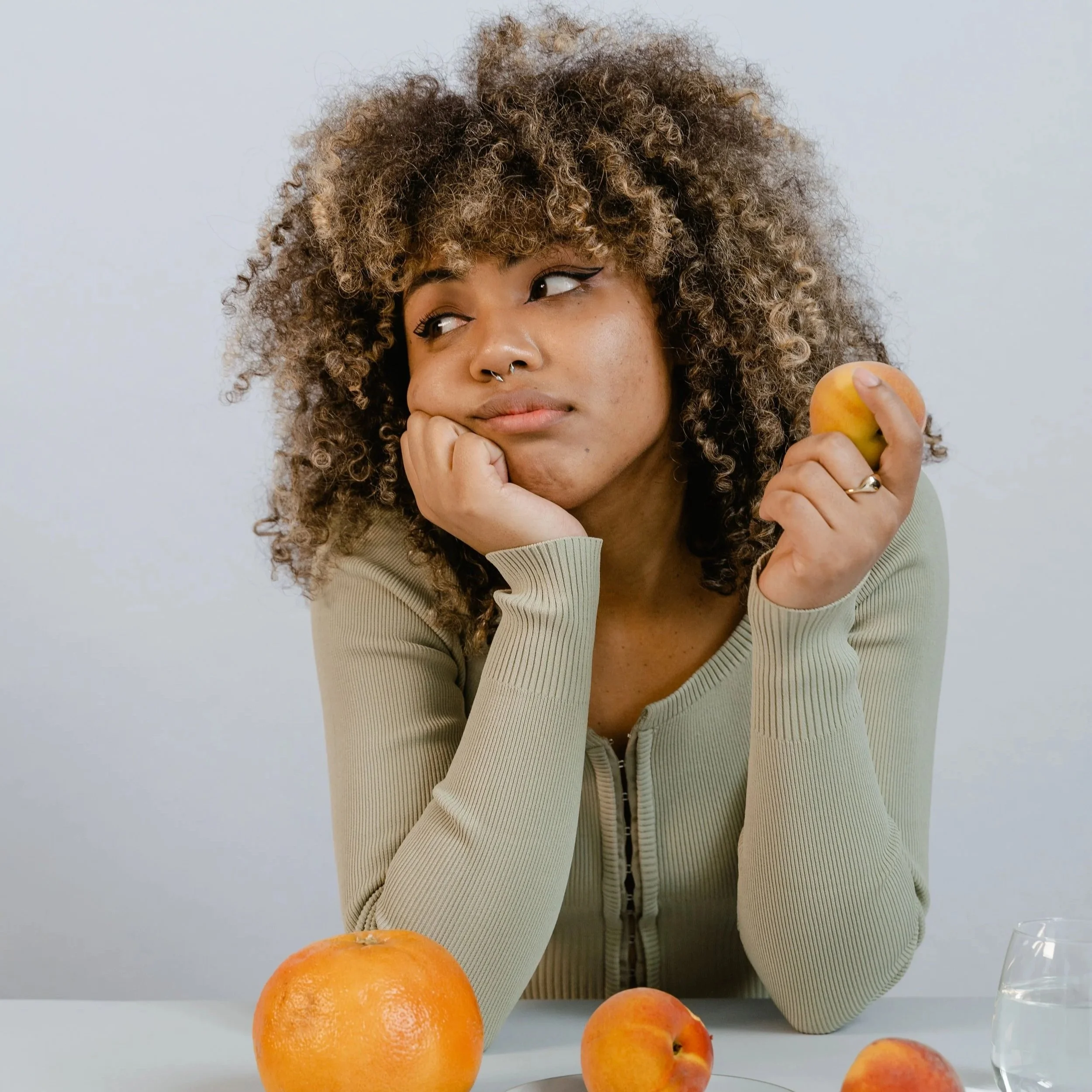 Woman reflecting, illustrating how social comparison can influence happiness and self-worth.