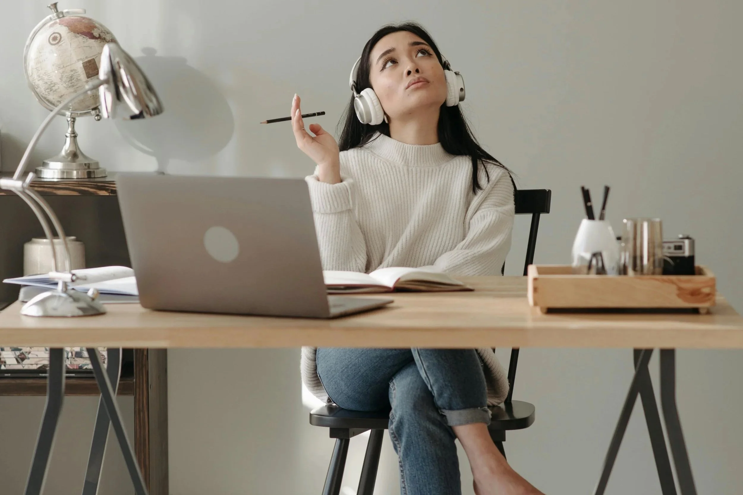 woman sitting looking up thinking