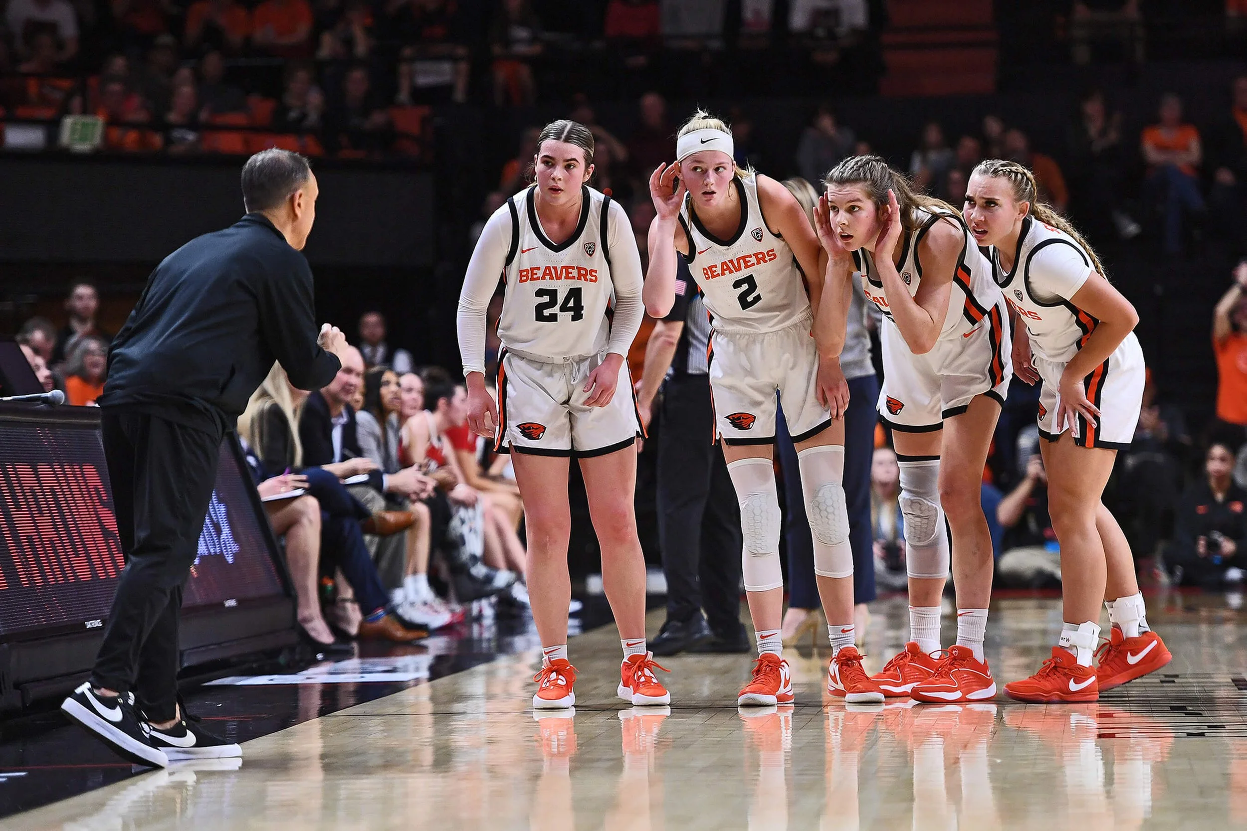 From left, Adlee Blacklock, Lily Hansford, Kelsey Rees and Kennedie Shuler listen to instructions from OSU coach Scott Rueck in 2024 (courtesy Dave Nishitani)