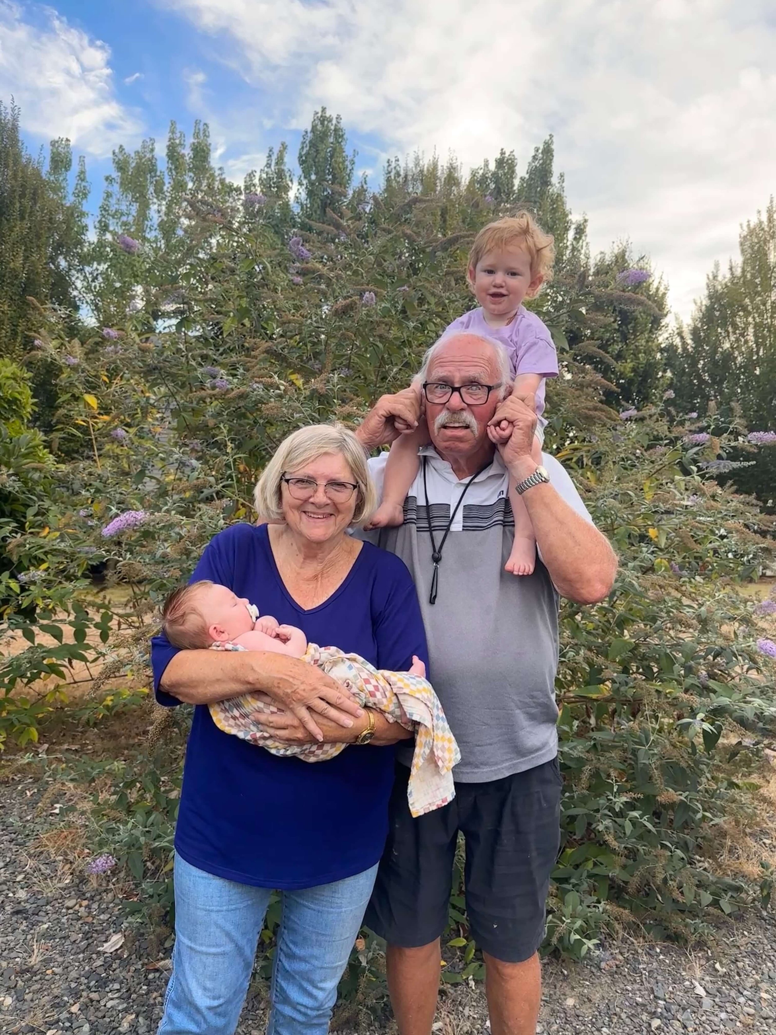 Coach Ken Hodge and significant other Carol Lee Robinson. Carol is holding Myah; Ken is holding Millie. (courtesy Ken Hodge)