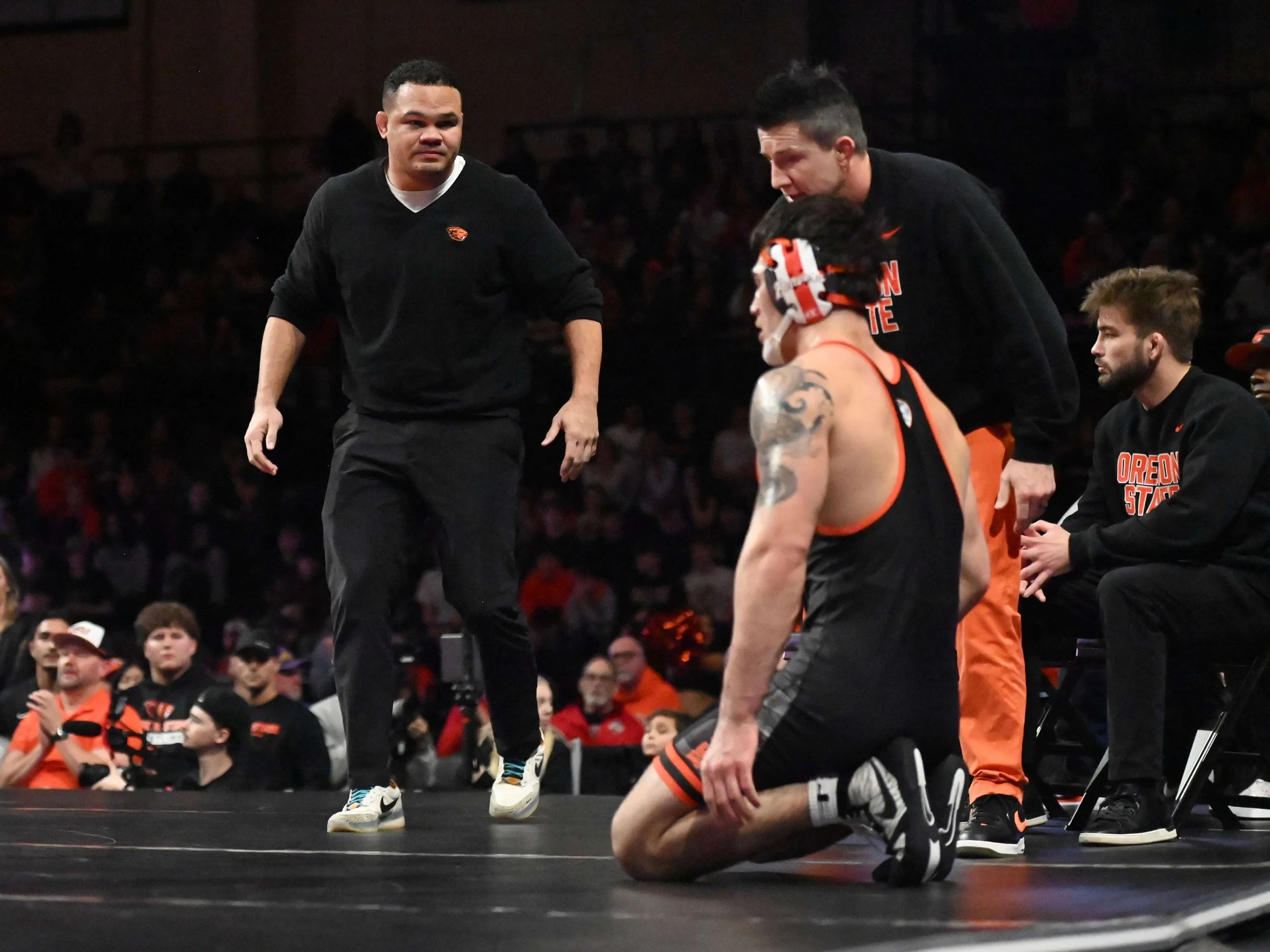 Coach Chris Pendleton, here with assistants Josh Rhoden and Cory Crooks, approaches Justin Rademacher during a timeout in his 197-pound win over Ohio State’s Luke Geog (courtesy Dominic Cusimano)